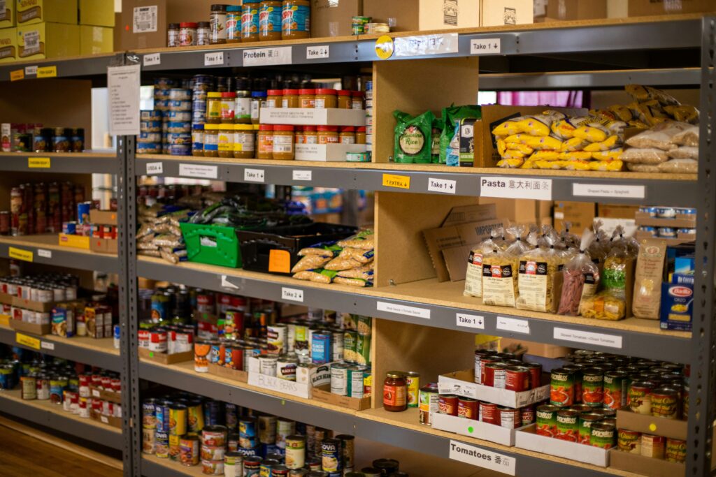 Fully stocked shelves at a food pantry, providing essential items for those in need.